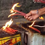 Lighting Candles Outside Basilica Del Santo Nino in Cebu City