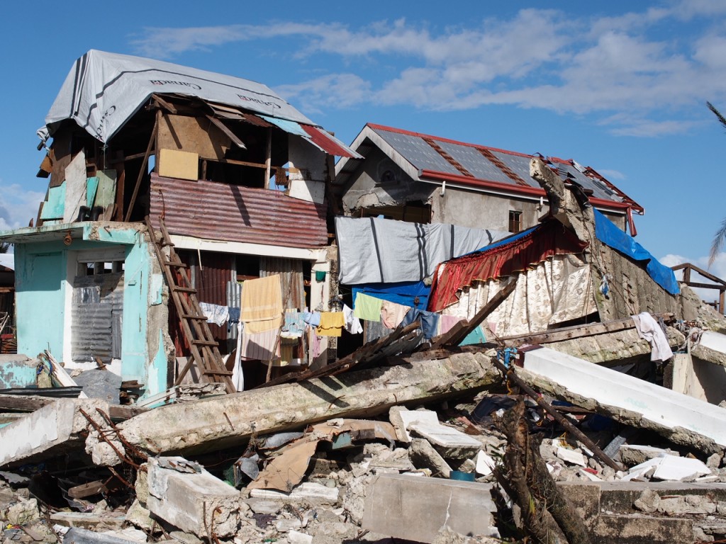 Many houses covered their exposed new roofs with tarps donated by the Canadian government