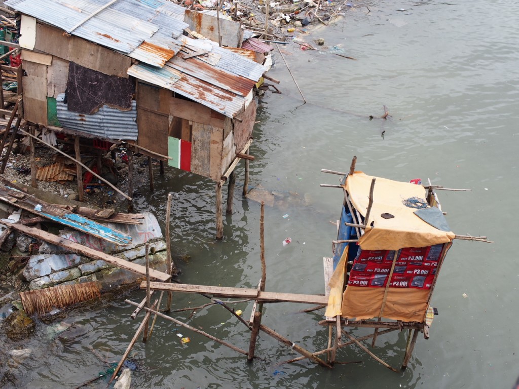 A new house and a new latrine built on stilts over the water after super typhoon Yolanda