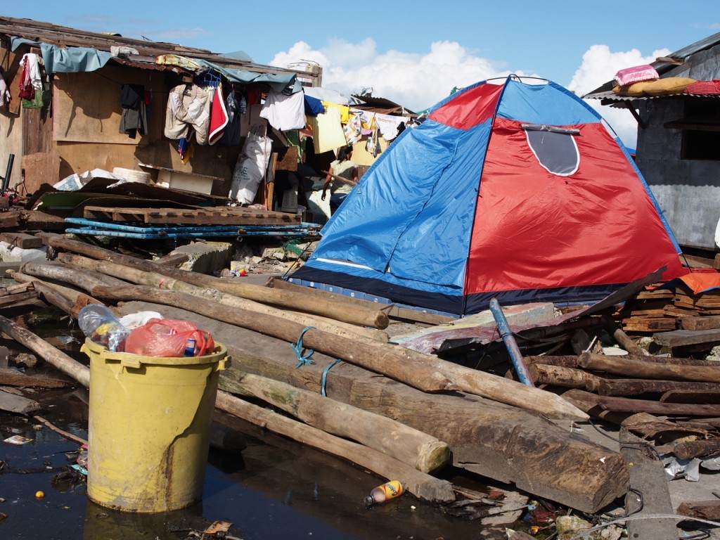 A family lives inside a small tent after super typhoon Yolanda