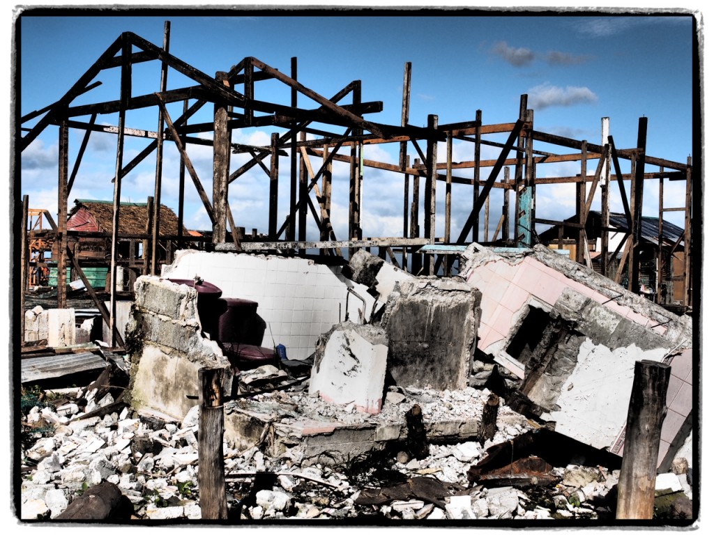 Putting up a wooden frame house to replace the cement one that was destroyed