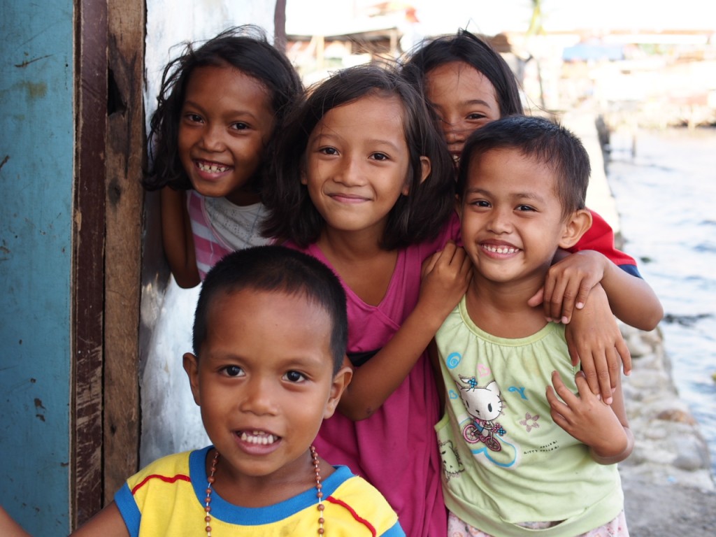 A group of children in Tacloban smile for the camera