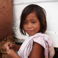This young girl was hanging out with her friends inside a truck destroyed by the typhoon