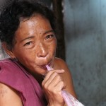 Woman Drinking a Soda on Copra Street